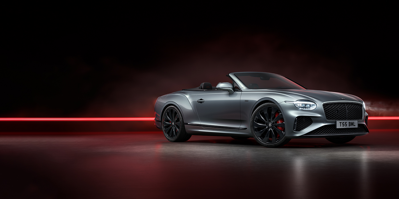 Bentley Brussels Bentley Continental GTC Black Edition convertible front three quarters in Hallmark silver against a dark grey and red background