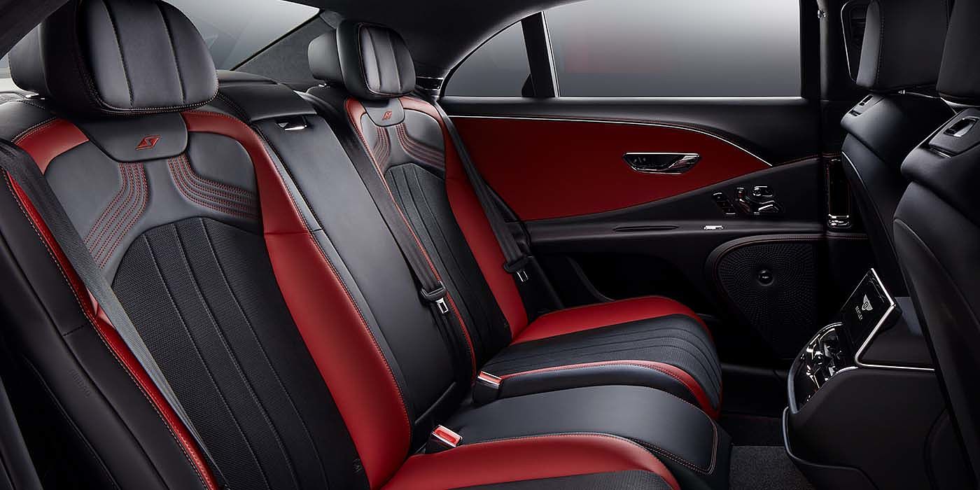 Bentley Brussels Bentley Flying Spur S sedan rear interior in Beluga black and Hotspur red hide with S stitching