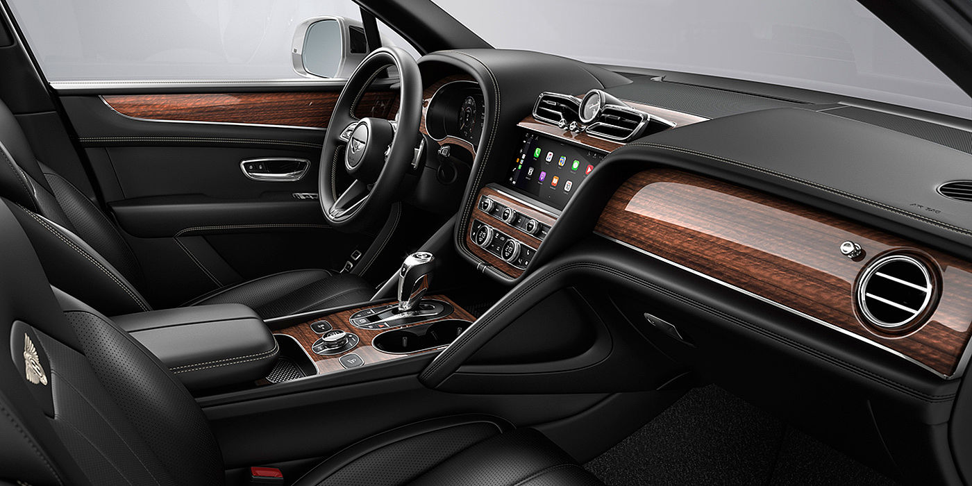 Bentley Brussels Bentley Bentayga interior with a Crown Cut Walnut veneer, view from the passenger seat over looking the driver's seat.