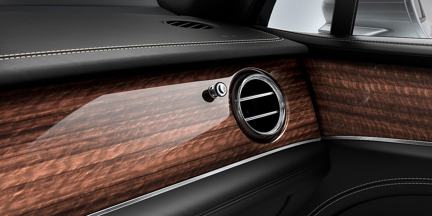Bentley Brussels Bentley Bentayga front interior Crown Cut Walnut veneer and chrome air vent.
