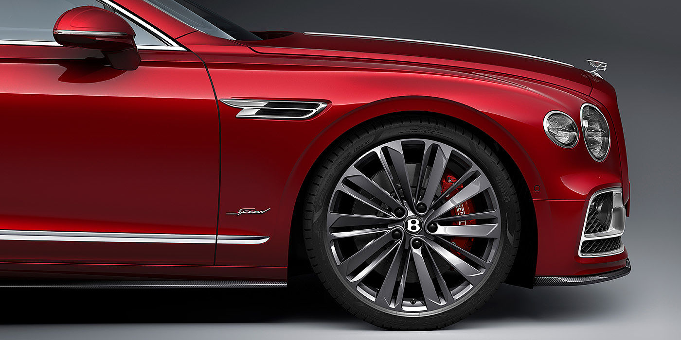 Bentley Brussels Bentley Flying Spur Speed sedan front wheel in close up with Dragon Red II paint