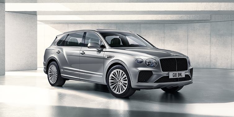 Bentley Brussels Bentley Bentayga Extended Wheelbase SUV front three quarter in Moonbeam paint with a grey background