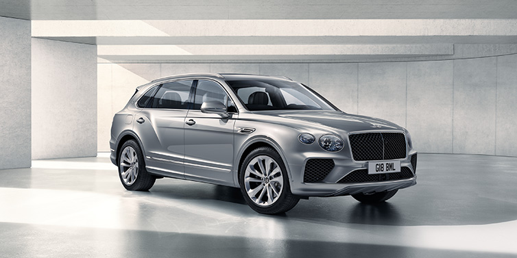 Bentley Brussels Bentley Bentayga Extended Wheelbase SUV front three quarter in Moonbeam paint with a grey background