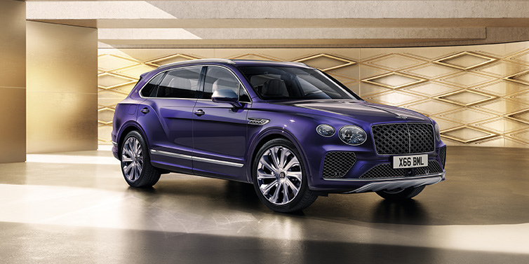 Bentley Brussels Bentley Bentayga Extended Wheelbase Mulliner SUV front three quarter in Tanzanite Purple paint with a gold patterned background