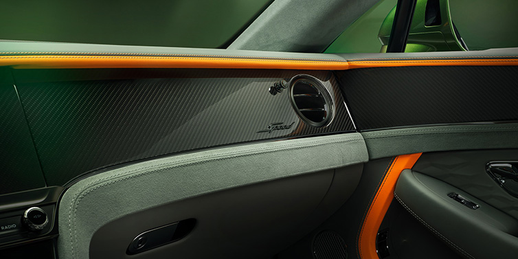 Bentley Brussels Bentley Continental GT Speed coupe front interior dash detail with high gloss carbon fibre veneer surrounded by Mandarin by Mulliner and Gravity Grey hides