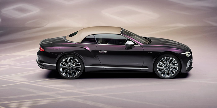 Bentley Brussels Bentley Continental GTC Mulliner convertible in profile with hood up, in Tanzanite Purple paint and 22 inch Mulliner painted and polished wheels