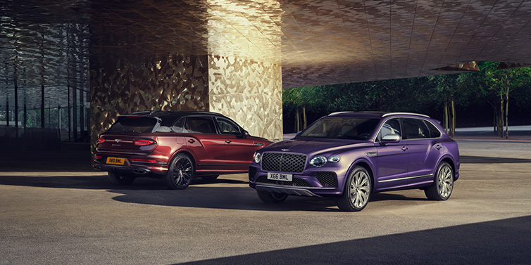 Bentley Brussels A duo of Bentley Bentayga Extended Wheelbase Mulliner SUVs parked in a city environment, with Tanzanite Purple and Cricket Ball red exterior paint