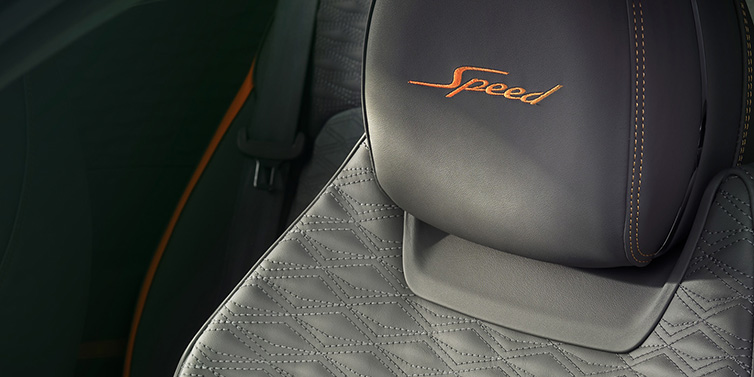 Bentley Brussels Bentley Continental GT Speed coupe seat detail in Gravity Grey hide and Speed emblem in Mandarin by Mulliner coloured embroidery