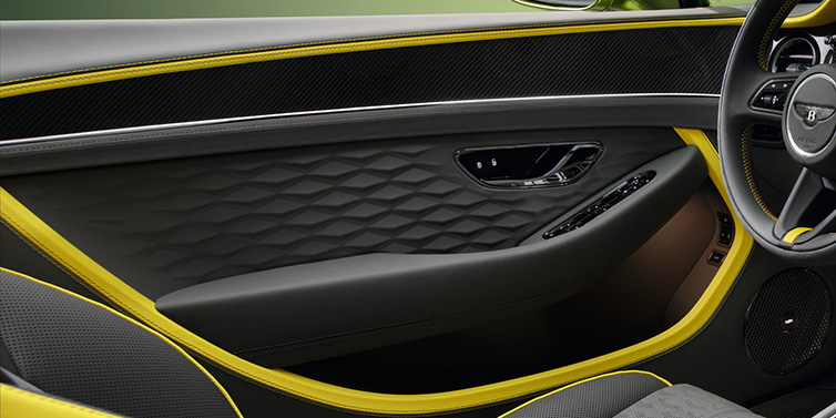 Bentley Brussels Bentley Continental GTC Speed convertible interior door details featuring Gravity Grey and Cyber Yellow by Mulliner hides and high gloss carbon fibre veneer