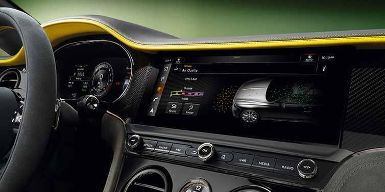 Bentley Brussels Bentley Continental GTC Speed convertible front interior centre console with MMI screen showing Air Quality visualisation surrounded by Cyber Yellow by Mulliner and Gravity Grey hides and high gloss carbon fibre veneer