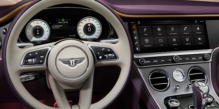 Bentley Brussels Bentley Continental GTC Mulliner convertible steering wheel and drivers screens surrounded by Damson purple and Linen hides